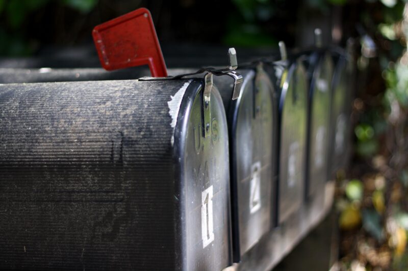 Eine Reihe amerikanischer Briefkasten. Beim vorderen ist die rote Flagge hoch.